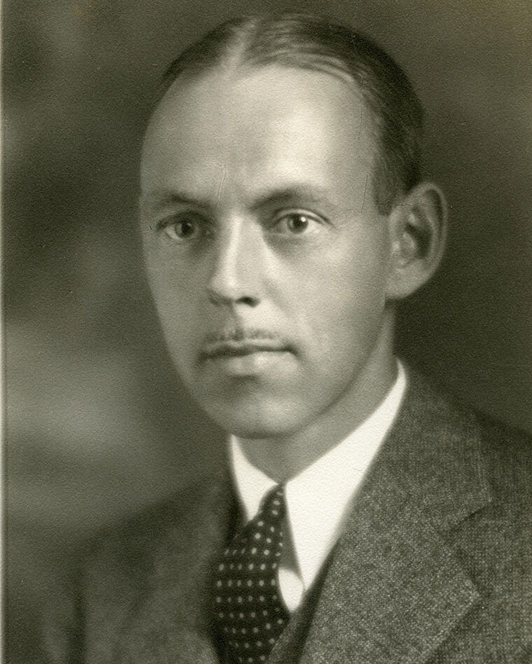Black and white headshot of U-M's Robert Cooley Angell, circa 1920, caucasian man in suit and tie.
