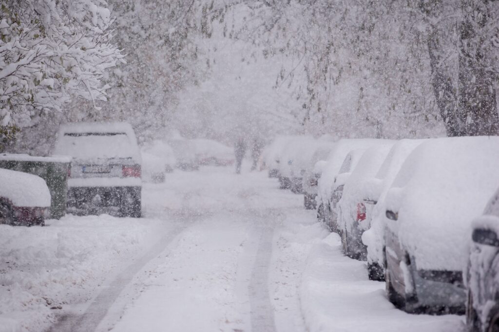 Parked cars covered with snow - snow storm. Image credit: Adobe Stock